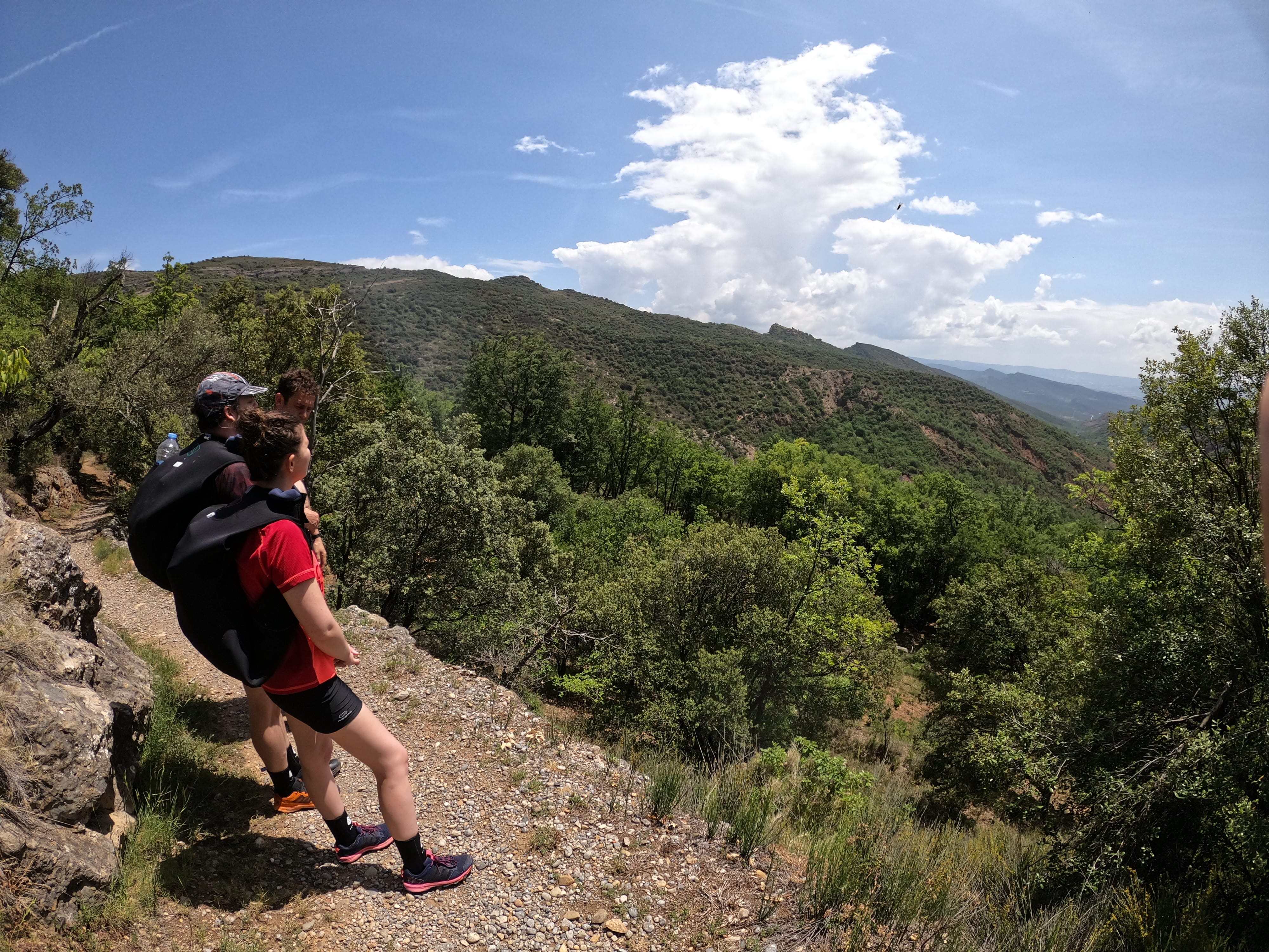 Two participants in canyoning gear enjoying the mountain landscape during the approach to Barranco de Gurp