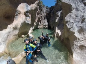 Group of canyoners enjoying the turquoise pools of Peonera Canyon