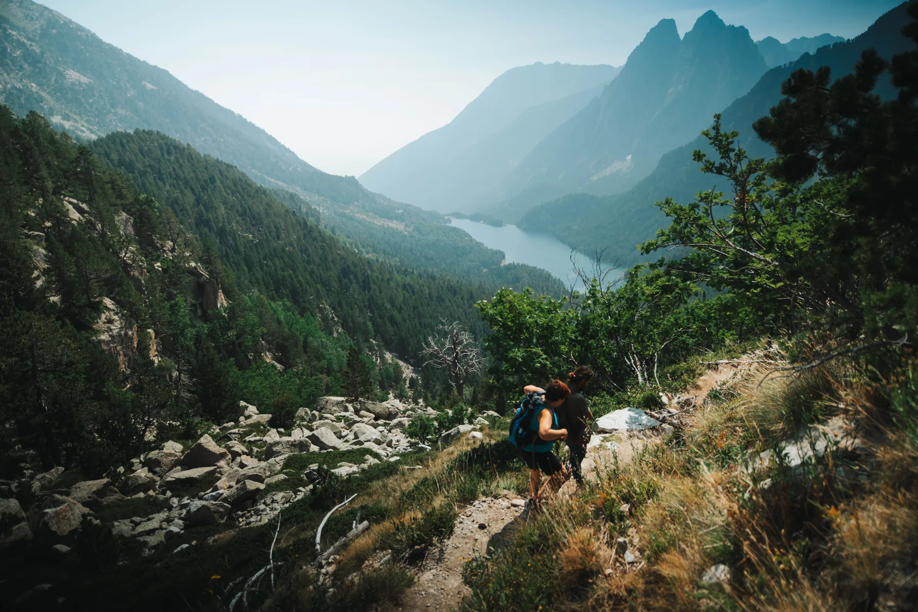 Senderistas recorriendo un camino de montaña en el Parque Nacional de Aigüestortes.